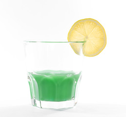 Green absinth cocktail decorated with lemon slice