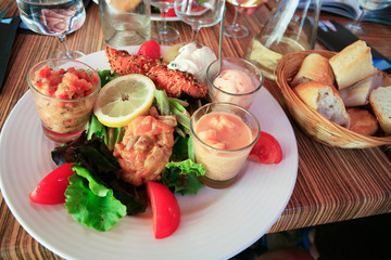 plate of big salad with salmon carpaccio and sorbet