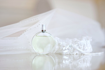 Wedding veil, perfume bottle and a garter