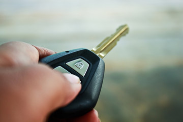 holding car key