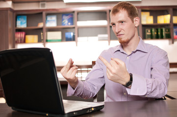 Fototapeta premium Emotional businessman with laptop