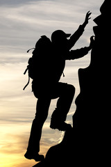 silhouette of a traveler tourist mountaineer on sunrise