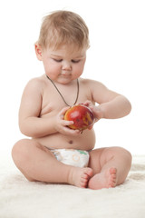 Sweet small baby with apple.