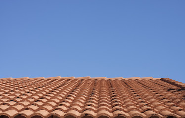 Red Clay Tile Roof Under a Clear Blue Sky