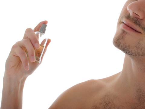 Macro Shot Young Male Spray Perfume On His Skin. Isolated On Whi