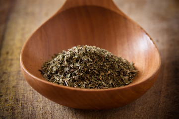 Oregano on wooden spoon