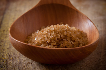 Pile of brown sugar in wooden spoon