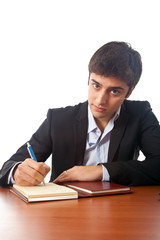 Businessman writing on the agenda at the office