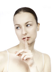 Young girl with her finger over her mouth