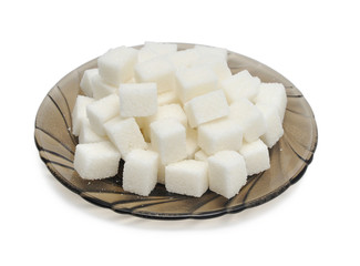 Cubes of sugar on the black plate