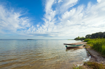Fototapeta na wymiar boat near the summer lake shore