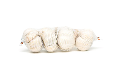 net with garlic on white