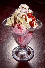Fruit with ice-cream and cream with chocolate topping.