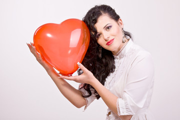 Woman with red heart balloon on a white background
