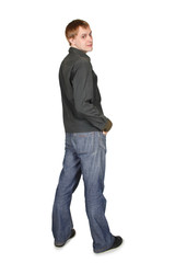 young handsome man in grey shirt standing and looking back, hand