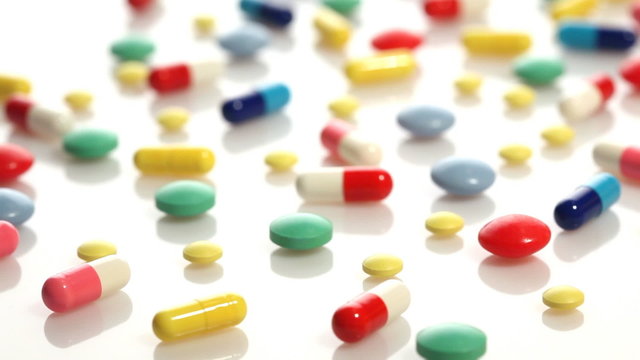 Colorful pills over white background
