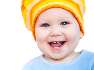 Smiling baby girl showing teeth wearing a  hat