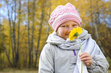 little girl with a yellow flower