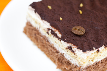 cake at the plate lying on an orange cloth