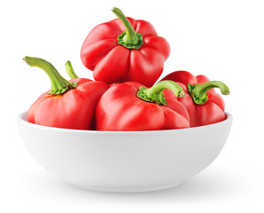 Isolated peppers. Pile of red bell peppers in a bowl isolated on white background
