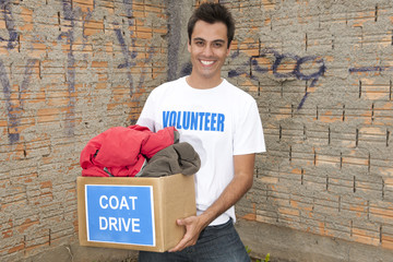 volunteer with coat drive donation box