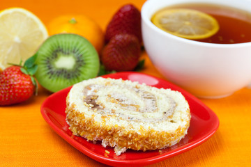 lemon,lemon tea,mandarin,kiwi,cake and strawberries lying on the
