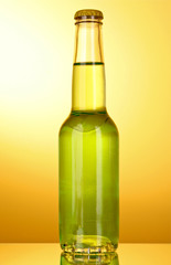 Bottle with a green alcoholic beverage on a yellow background