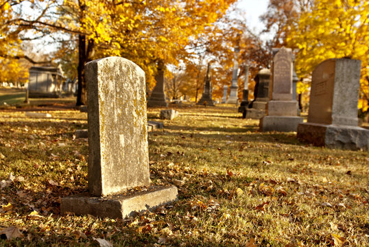 Tombstone At Cemetery In Fall