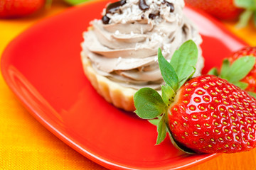 lemon,mandarin,kiwi,cake and strawberries lying on the orange fa