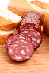 Sausage and bread on wooden surface