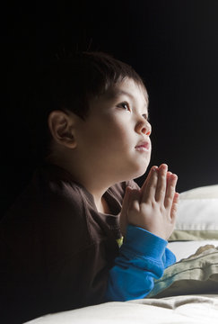 Saying his prayers before bed.