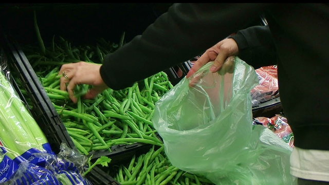 Woman Selecting Green Beans In Produce