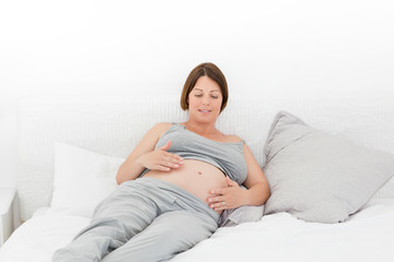 Naklejka premium Pregnant woman cuddling her belly
