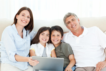 Pretty family looking at the camera at home