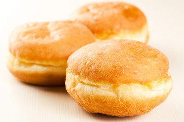 Sugary doughnut studio isolated on a wooden background. Shallow