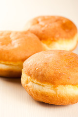 Sugary doughnut studio macro at wooden background. Shallow depth