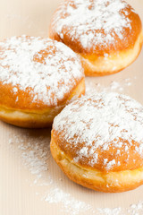 Sugary doughnut studio macro at wooden background. Shallow depth
