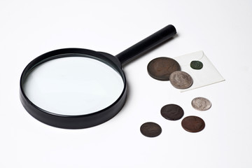 Old Coins and Magnifying Glass