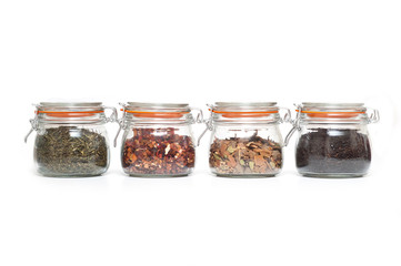 glass jars with different types of tea in them