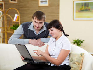 couple with a laptop at home