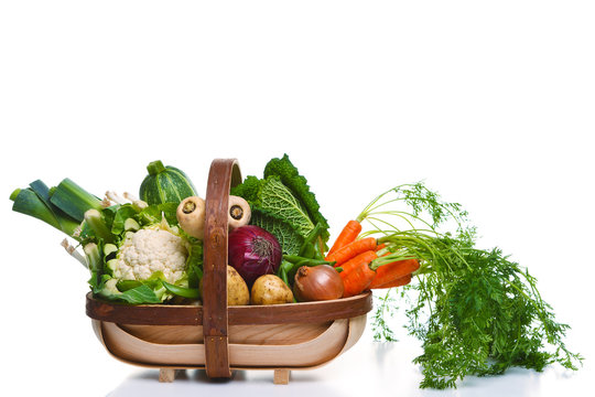 Fototapeta Trug full of organic vegetables isolated on white