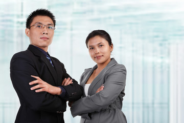 Two Asian business people pose