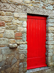 Red door with antique stone hitching post