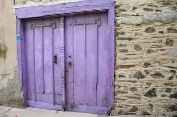 purple painted wooden door and wall