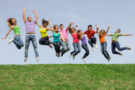group of happy kids or teens jumping