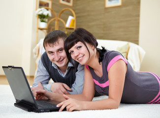 couple with a laptop at home