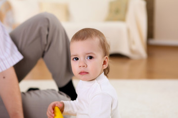 Fototapeta premium young family at home playing with a baby