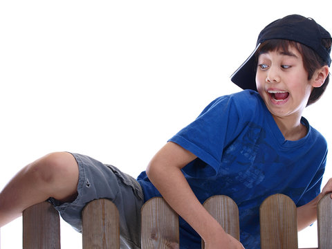 Boy Climbing Over The Fence