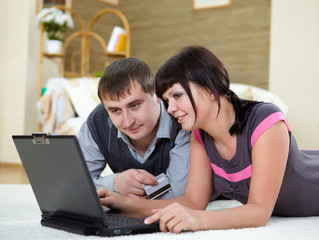couple with a laptop at home