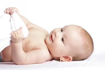 Adorable baby of six months with his bathrobe.
